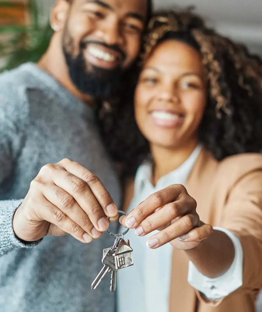 Couple holding the keys to their first home