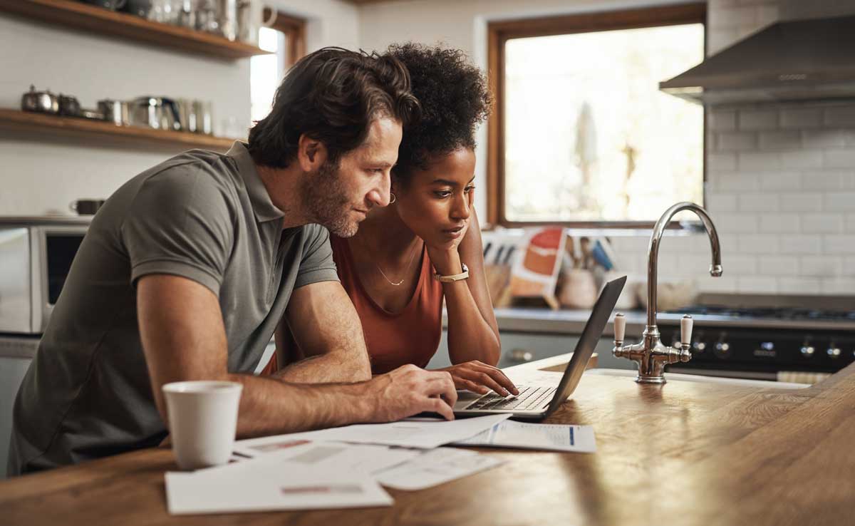 Couple reviewing loan options on a laptop