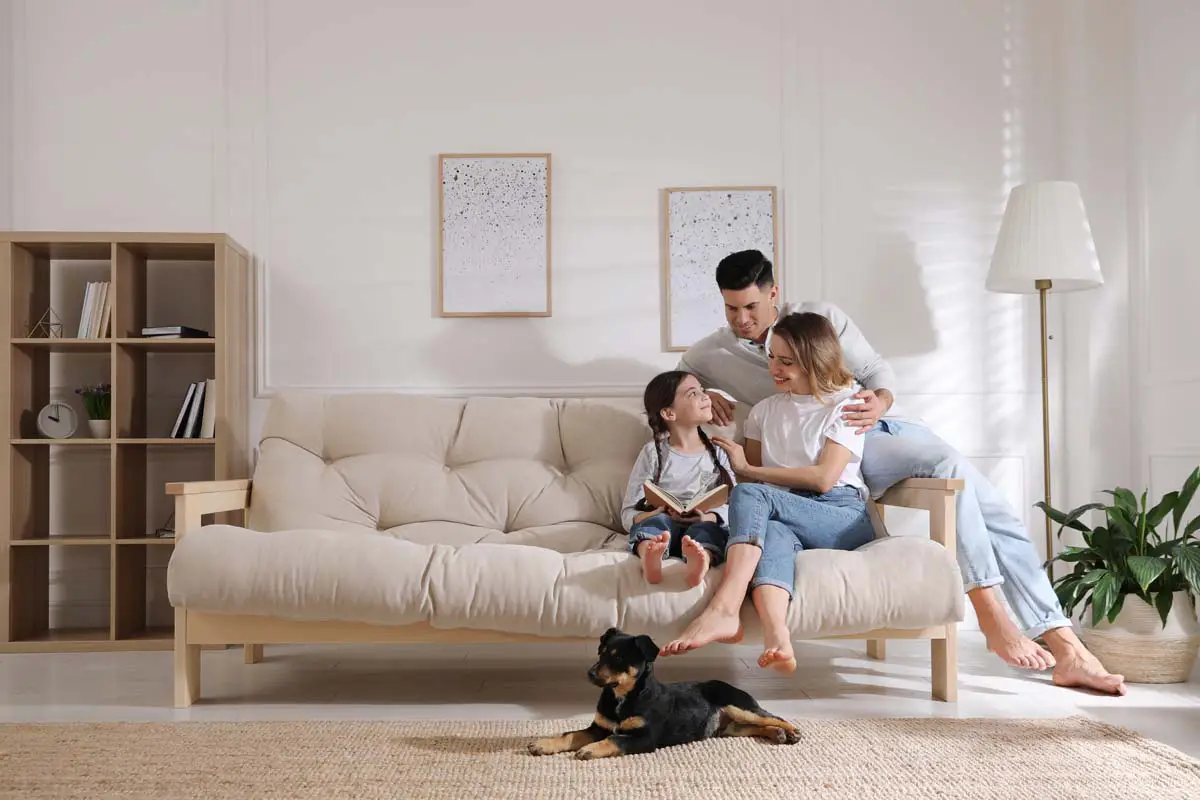 Family relaxing at home with their dog